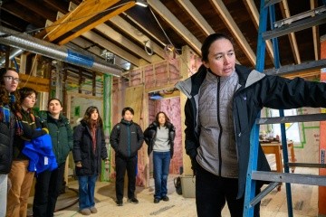 Five College Associate Professor of Sustainable Architecture Naomi Darling (far right) guides Mount Holyoke College students through the renovations of the Phoenix on campus.