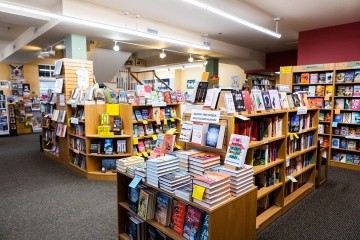 Odyssey bookshop, shelves filled with colorful books.