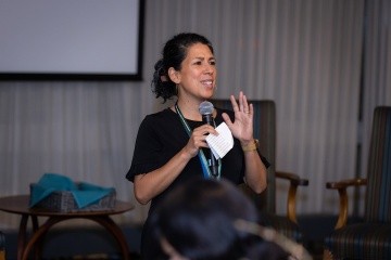 Olivia Aguilar speaking in front of an audience, photo by Jo Chattman.