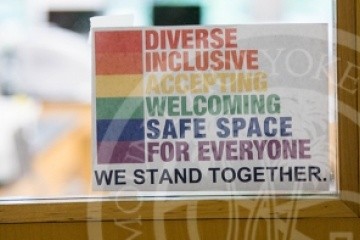 Sign on door that reads &quot;Diverse, Inclusive, Accepting, Welcoming, Safe Space for Everyone, we stand together&quot;.