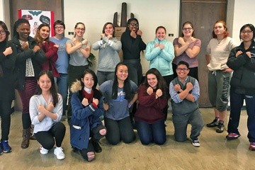 The students of Jennifer Matos’ first-year seminar, Wonder Woman: The Original Social Justice Warrior, strike the heroine’s iconic pose at the end of the semester with their professor (first row, far right).