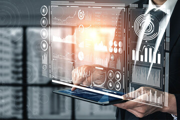 A person holds a tablet, a holographic display in front of them.