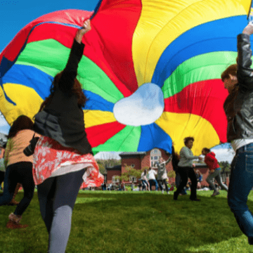 Students having fun with a colorful parachute on Pangy Day