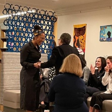 Dr. Beverly Daniel Tatum is greeted as she makes her way to the front of the room.