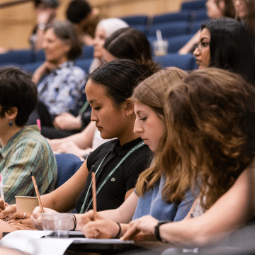 MWCE Climate Justice Summit audience taking notes.