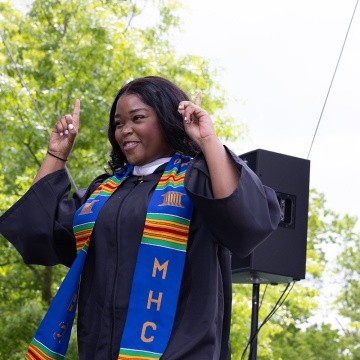 Mount Holyoke Commencement 2024 - Student in robes celebrates
