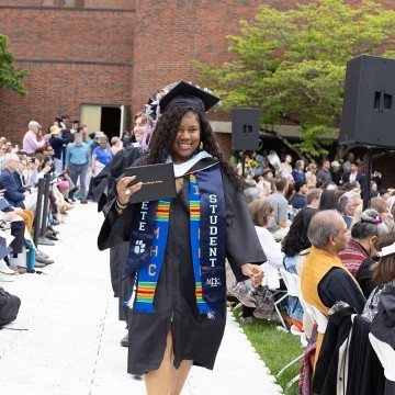 Mount Holyoke Commencement 2024 - Student in robes walks down the aisle