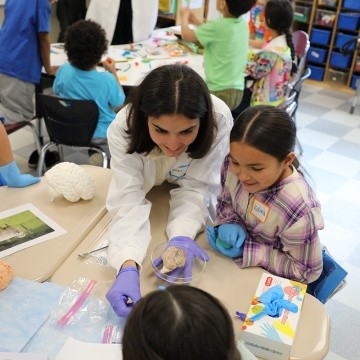MHC Student engages with first graders during brain activity workshop.
