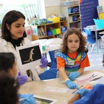 MHC student engages with first graders during a brain workshop.