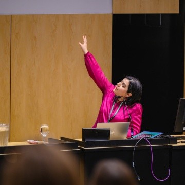 Speaker points to a screen at the Summit on Feminist Leadership in Climate Justice held at Mount Holyoke College on April 25, 2025