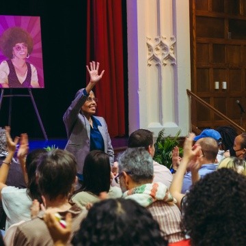 Barbara Smith stands to applause during the Angela Y. Davis presentation.