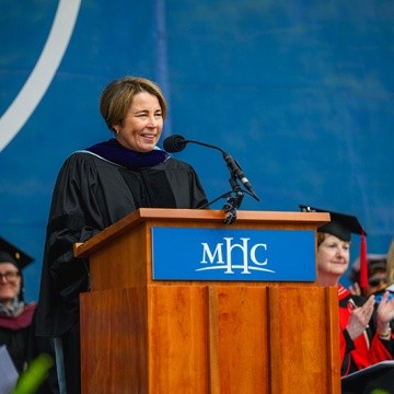 Governor Maura Healey speaking at the podium during Mount Holyoke’s Commencement Ceremony