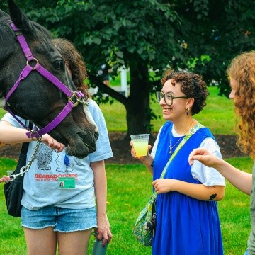 Mount Holyoke College New Student Orientation - Students greeting a horse