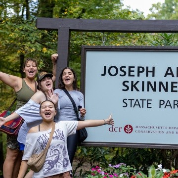 Mount Holyoke students pose in front of the Joseph Allen Skinner State Park sign