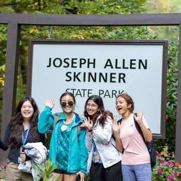 Mount Holyoke students pose in front of the Joseph Allen Skinner State Park sign