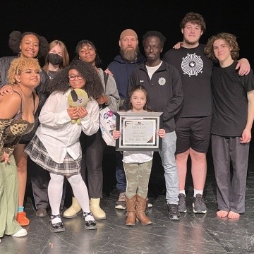 TOCLC Attendees pose together on stage holding certificate.