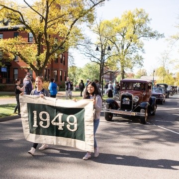 The class of 1949 riding in antique cars during the 2019 Laurel Parade