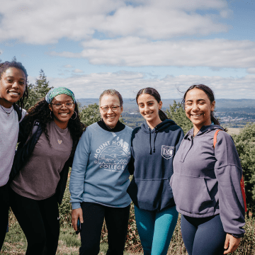 Students enjoying the view from the summit of Mount Holyoke with Interim President Beverly Daniel Tatum (center)