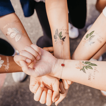 Students showing off their Mountain Day tattoos