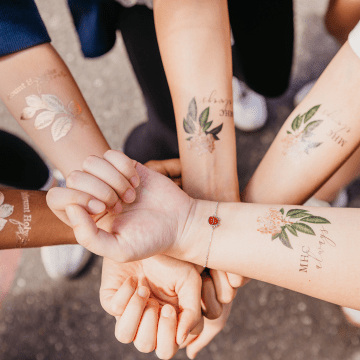 Students showing off their Mountain Day tattoos