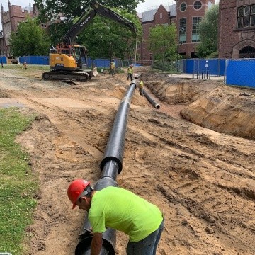 Laying down pipes during phase one of the geothermal project.