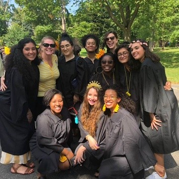 Smiling Posse graduates pose together in regalia.