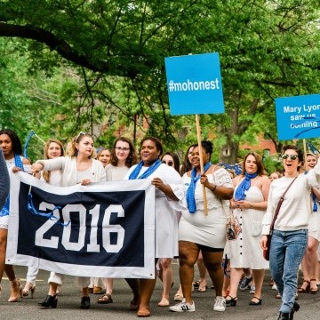 The class of 2016 marching with their class banner and blue signs during the Laurel Parade