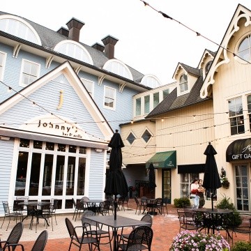 A courtyard by Johnny's Bar &amp; Grille in the Village Commons