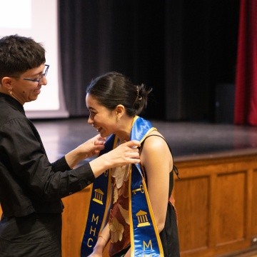 A student receives their stole during the ceremony