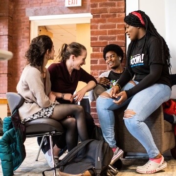 A small group of students having a discussion during the BOOM Learning Symposium