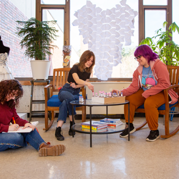 Three people enjoying the gathering space in the Art Building