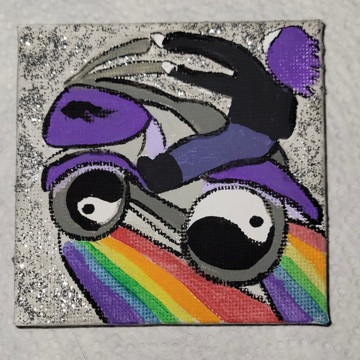 A Kindess Square with a painting of a person riding a bike with rainbows coming from the wheels