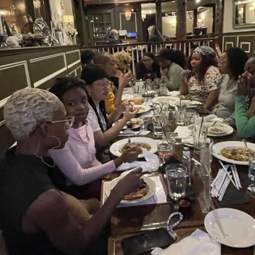 TOCLC attendees sit together having lunch.