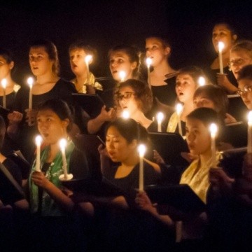 Students singing by candlelight during a Vespers concert