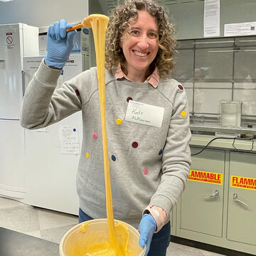 Professor Kate McMenamin shows off slime's elasticity.