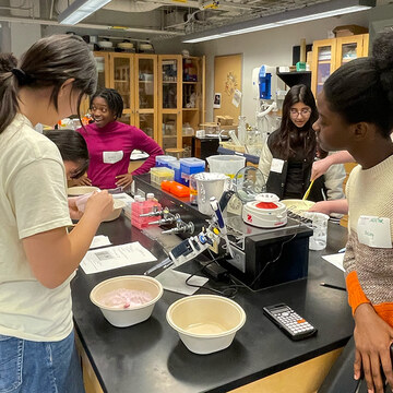 MHC students find fun in measuring ingredients.