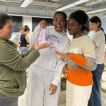 Students in the QIC stretch their finished pink slime.