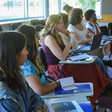 Student attendees listen to a panel presentation during the Money &amp; Mindfulness conference.