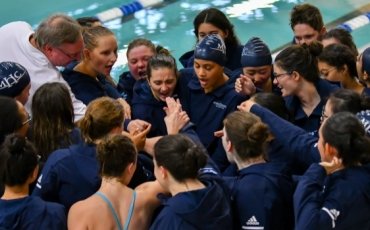 The swimming and diving team in a huddle