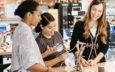 Three students collaborating on a project in the Fimbel Lab