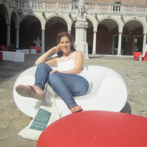 Kathryn Higgins '12 lounging in a courtyard in Italy