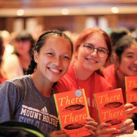 Students holding up their copies of There, There by Tommy Orange