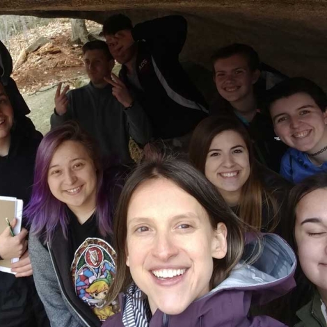 Katharine Hinkle ’02 and her geology students underneath a glacial erratic in Franconia Notch, NH.