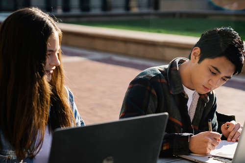 Students working outside on laptops