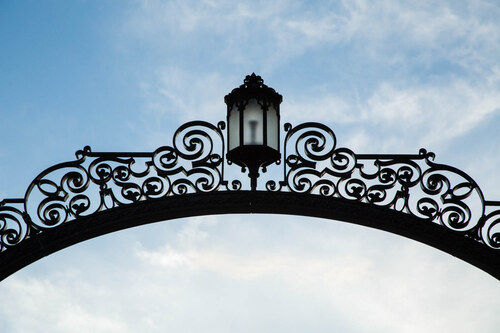 Gates and a blue sky with slight clouds. Photo taken by Ryan Donnell, 2017.