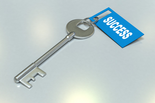 A key with a tag attached that is marked "Success"