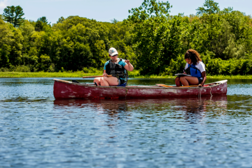 Students in a canoe taking samples
