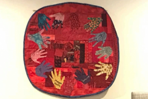 A colorful quilt that hangs in the Unity Center