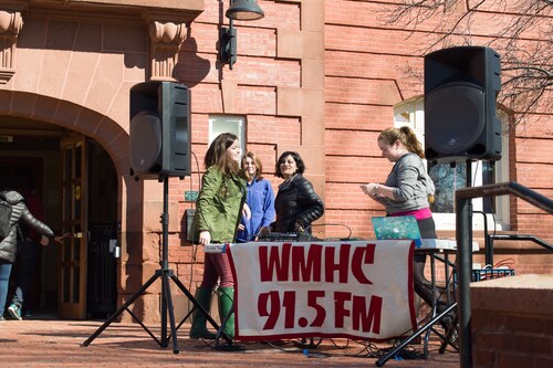 Students running a booth for WMHC outside the Blanchard Community Center