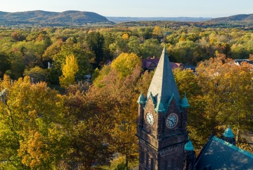 Aerial view of MHC, clocktower, the mountains in fall.